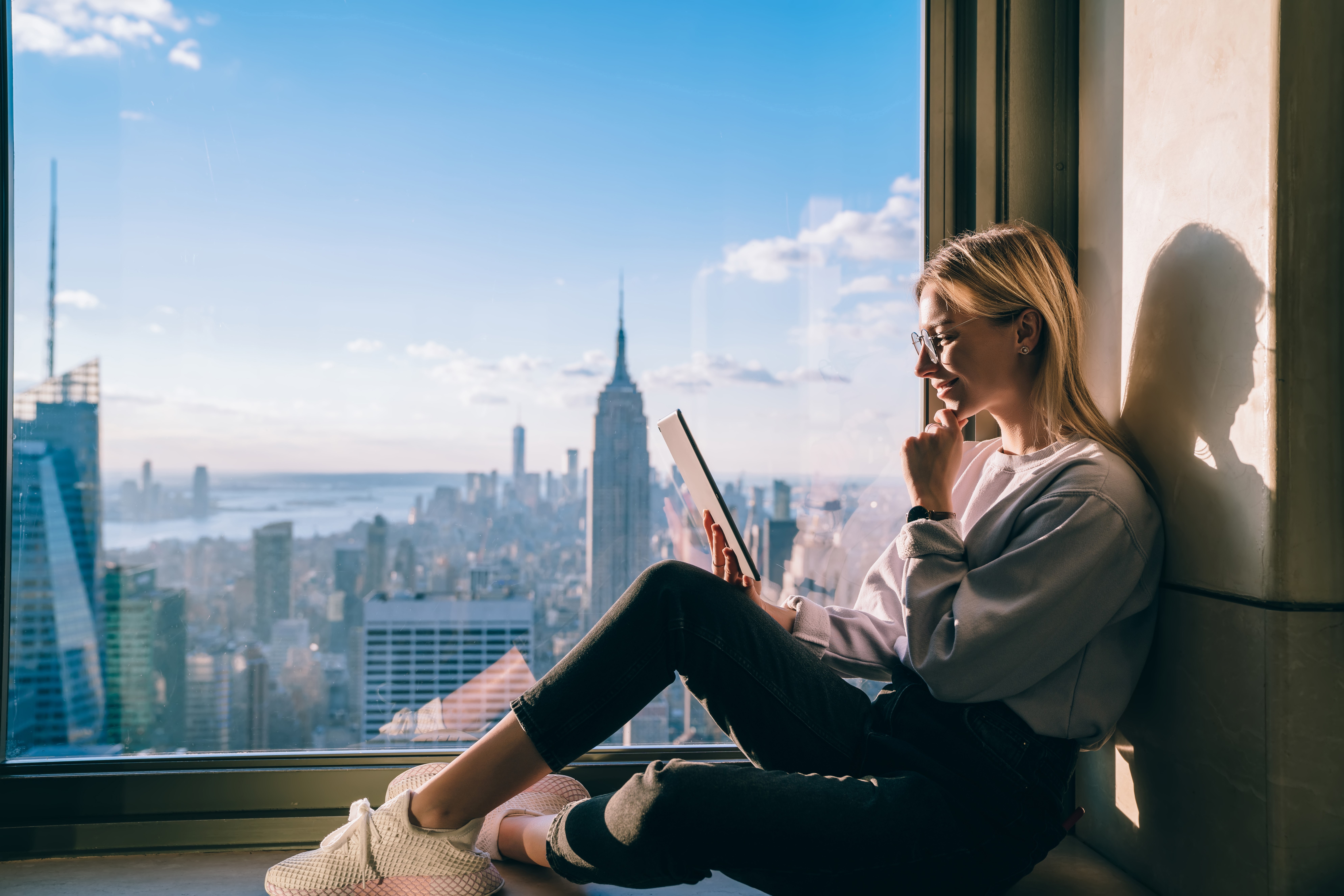 Women look at tablet with New York skyline- flipped